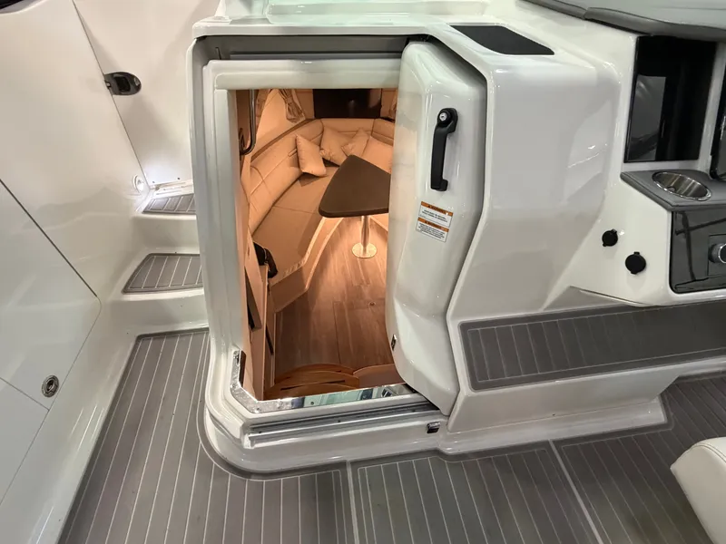 Slide: The Image of 2023 Sea Ray Sundancer 320 Outboard cabin entrance with modern interior and seating area. - 25