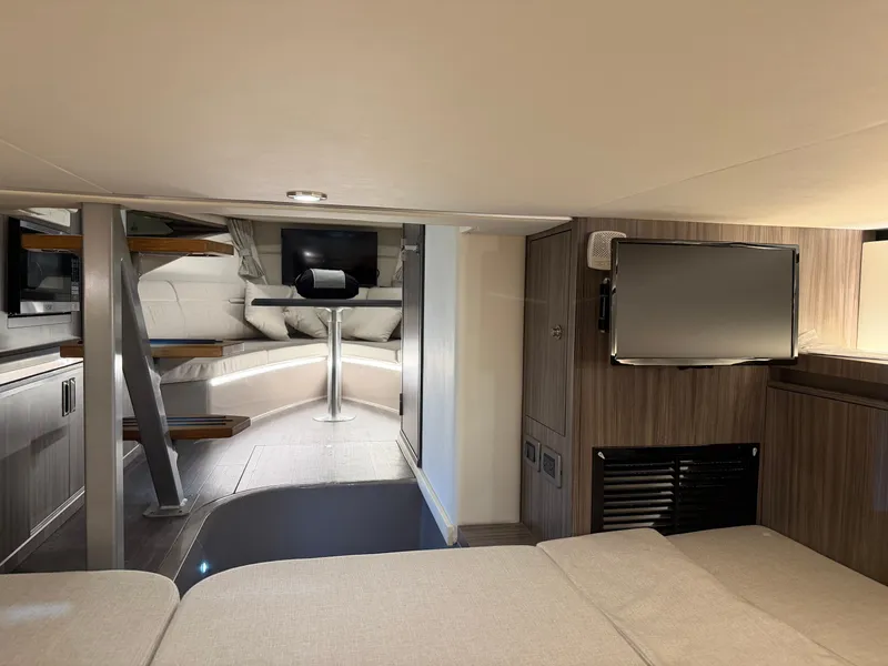 Slide: The Image of 2023 Sea Ray Sundancer 320 Outboard interior with modern furnishings and entertainment system. - 29