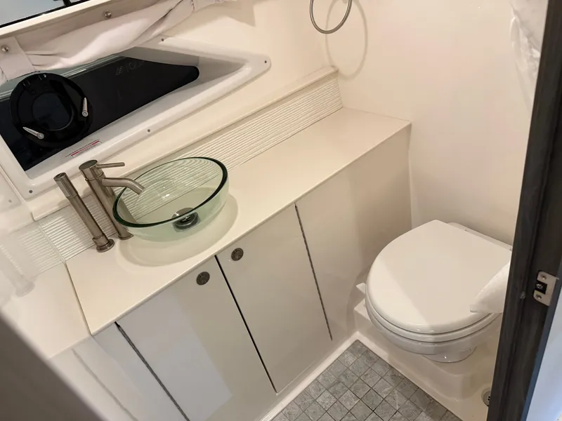 Slide: The Image of 2023 Sea Ray Sundancer 320 Outboard bathroom with modern sink and toilet. - 30