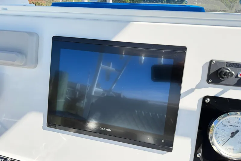 Slide: The Image of Garmin display on 2023 Clearwater 2200 CC boat dashboard with speedometer. - 10