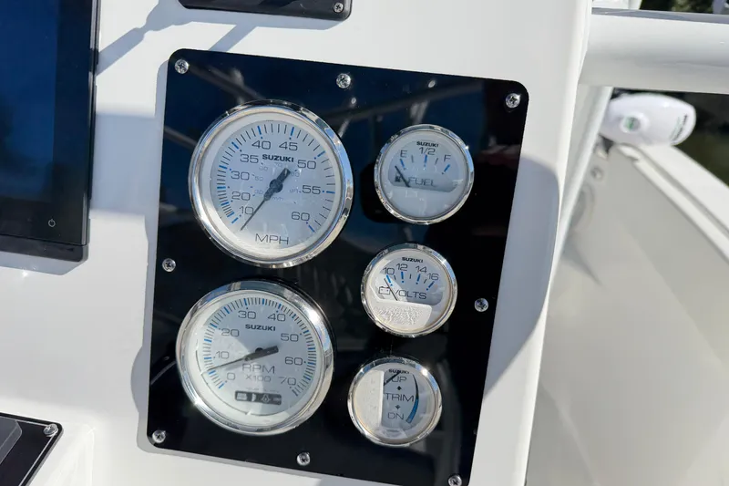 Slide: The Image of Dashboard of a 2023 Clearwater 2200 CC boat with Suzuki gauges. - 11