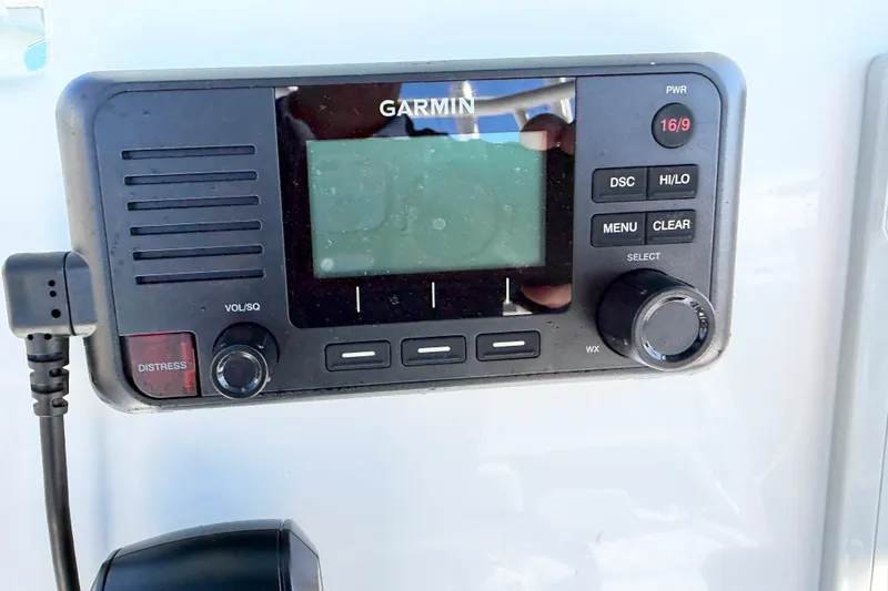 Slide: The Image of Garmin marine radio on 2023 Clearwater 2200 CC boat dashboard. - 13