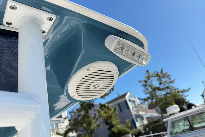 Slide: The Image of Close-up of 2023 Clearwater 2200 CC boat's speaker and light under blue sky. - 15