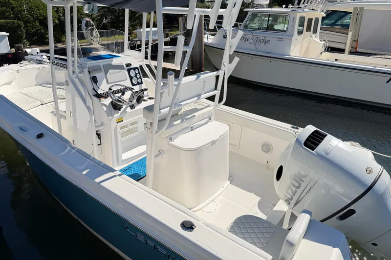 Slide: The Image of 2023 Clearwater 2200 CC boat with Suzuki engine, docked in marina. - 3