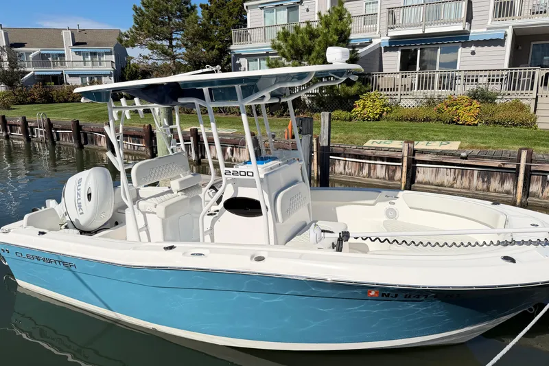 Slide: The Image of 2023 Clearwater 2200 CC boat docked by waterfront homes. - 4