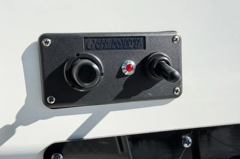 Slide: The Image of Control panel on 2023 Clearwater 2200 CC boat with toggle switch and indicator light. - 14