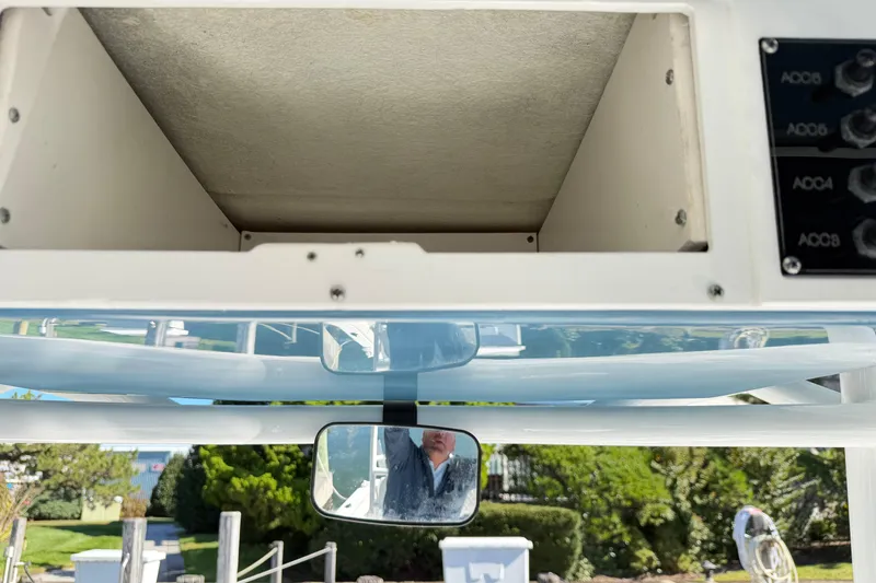 Slide: The Image of 2023 Clearwater 2200 CC boat console with storage compartment and control panel. - 16