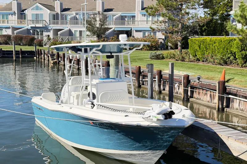 Slide: The Image of 2023 Clearwater 2200 CC boat docked by waterfront homes. - 5