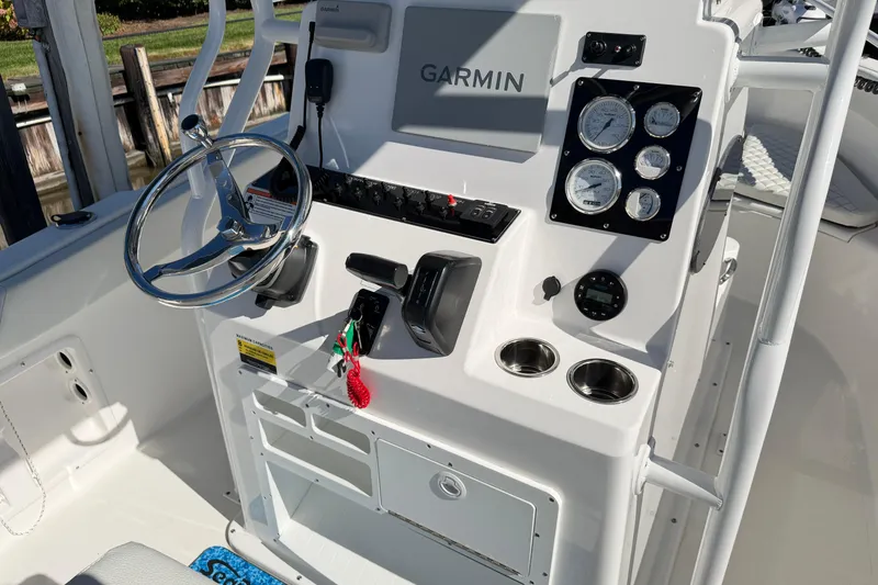 Slide: The Image of 2023 Clearwater 2200 CC boat console with Garmin navigation and steering wheel. - 9