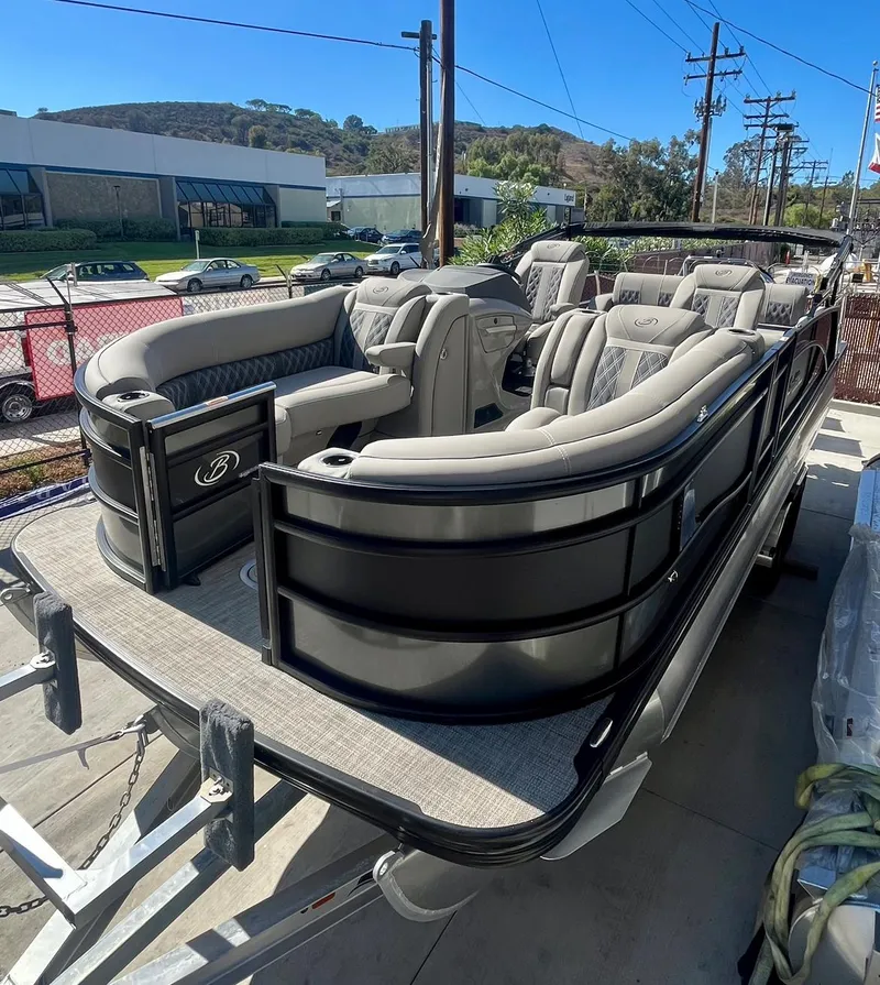 Slide: The Image of 2025 Barletta Lusso 23UC pontoon boat with luxurious seating and sleek design on a trailer. - 20