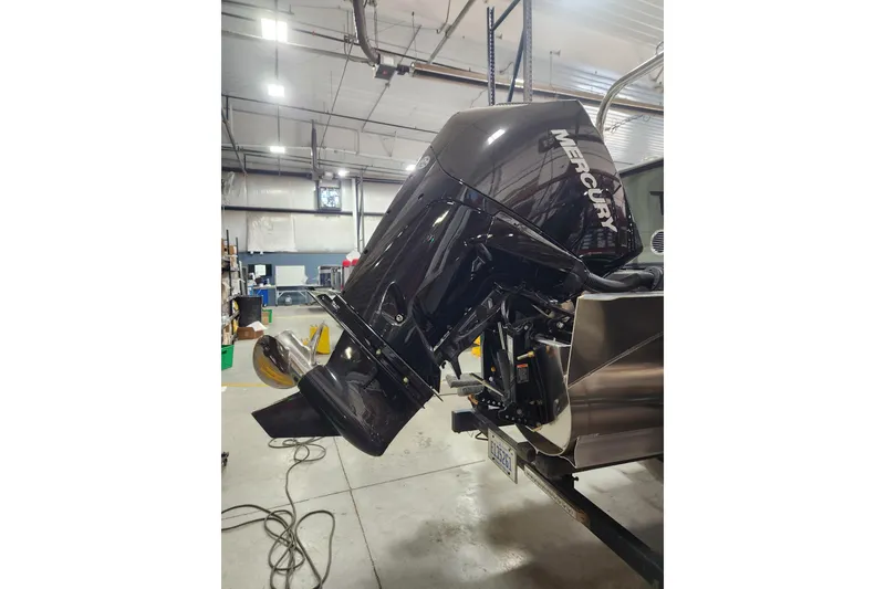 Slide: The Image of 2026 Avalon TRIPLETOON Venture CRB with Mercury outboard motor in a workshop setting. - 12