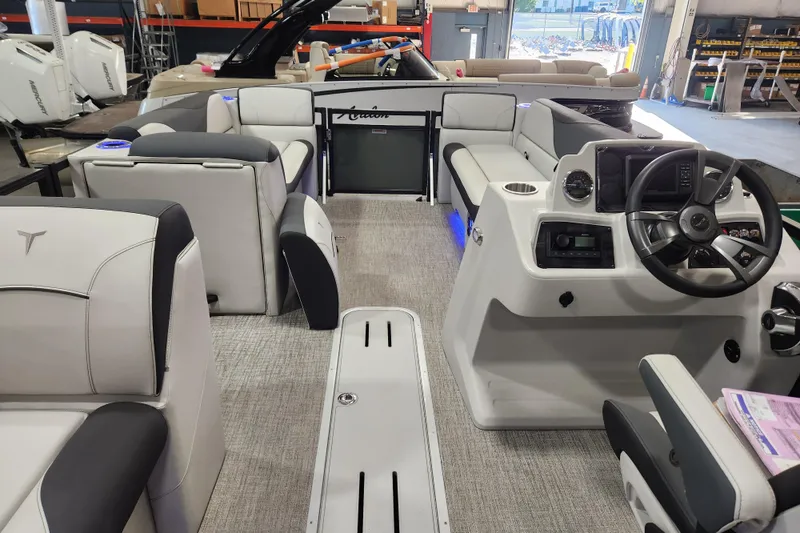 Slide: The Image of Interior of 2026 Avalon TRIPLETOON Venture CRB boat with modern seating and steering console. - 14