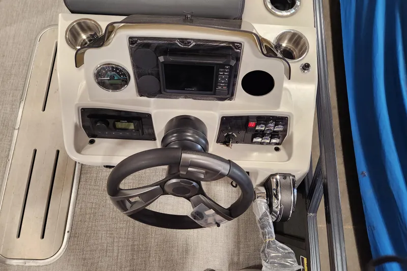 Slide: The Image of Steering console of 2026 Avalon TRIPLETOON Venture CRB with Patio Pad, featuring modern controls. - 19