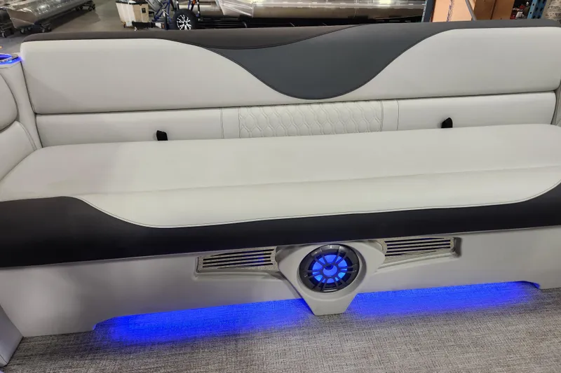 Slide: The Image of 2026 Avalon TRIPLETOON Venture CRB boat seat with blue LED lighting and modern design. - 6