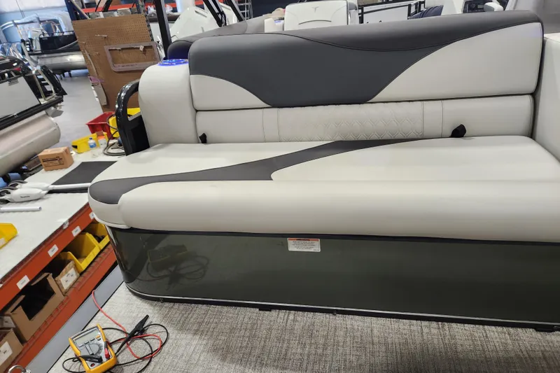 Slide: The Image of 2026 Avalon TRIPLETOON Venture CRB boat seat with modern design in workshop setting. - 9