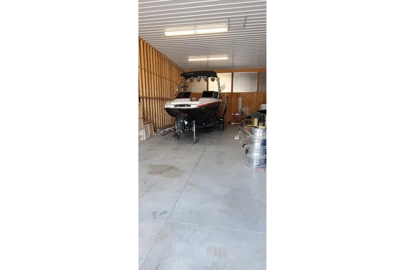 Slide: The Image of 2008 MasterCraft XStar 23 boat stored in a spacious garage. - 10