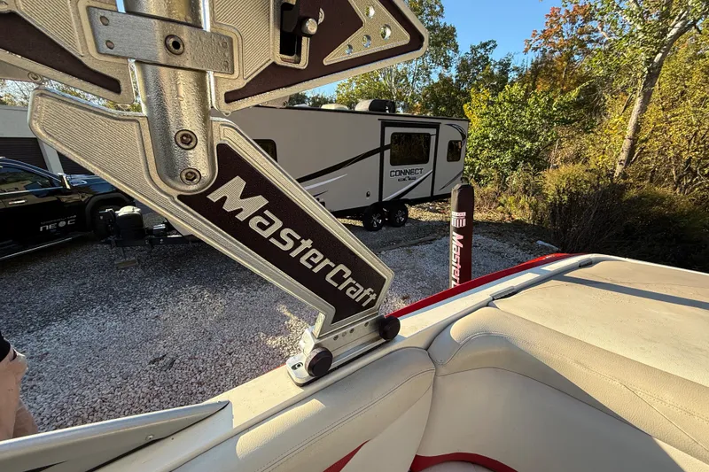 Slide: The Image of 2008 MasterCraft XStar 23 boat detail with trailer and trees in the background. - 15