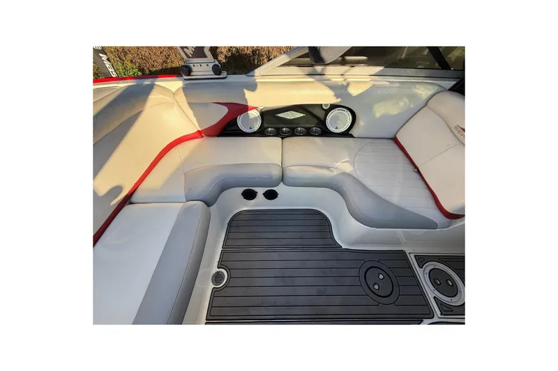 Slide: The Image of 2008 MasterCraft XStar 23 interior with white and red seating, black flooring. - 17