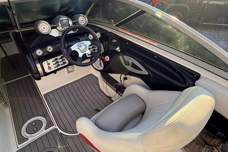 Slide: The Image of 2008 MasterCraft XStar 23 boat interior with steering wheel and dashboard controls. - 19