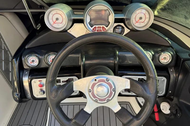 Slide: The Image of 2008 MasterCraft XStar 23 dashboard with steering wheel and gauges. - 20