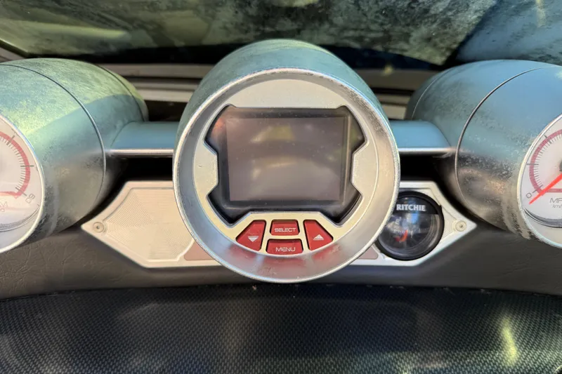 Slide: The Image of Dashboard of a 2008 MasterCraft XStar 23 boat with central display and gauges. - 21