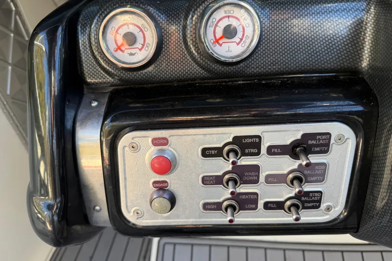 Slide: The Image of Dashboard controls of a 2008 MasterCraft XStar 23 boat, featuring gauges and switches. - 23