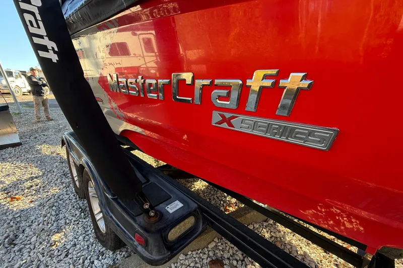 Slide: The Image of 2008 MasterCraft XStar 23 boat, red hull, X Series logo, on trailer. - 4