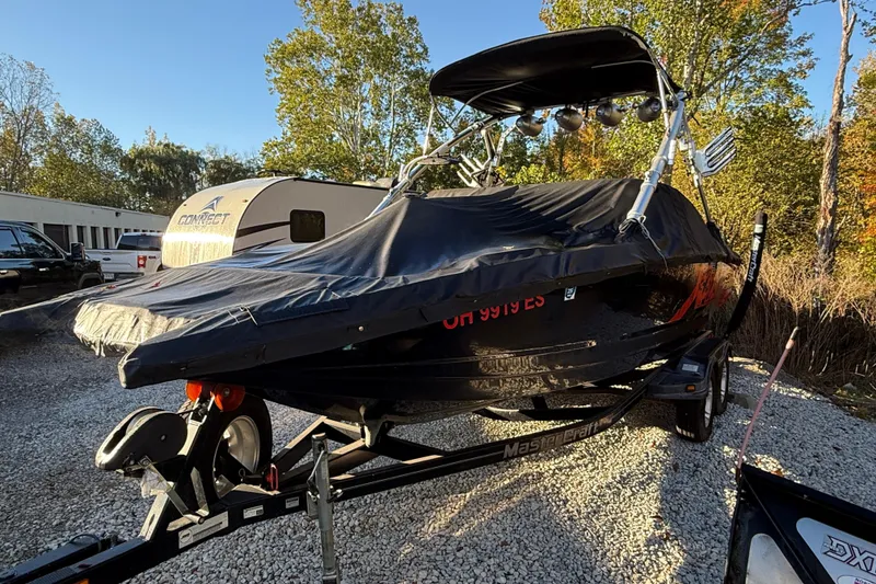 Slide: The Image of 2008 MasterCraft XStar 23 boat on trailer, covered, parked outdoors. - 5