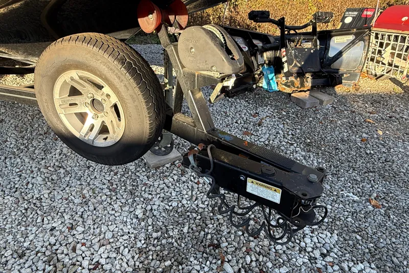 Slide: The Image of Trailer hitch and wheel of a 2008 MasterCraft XStar 23 on gravel surface. - 7