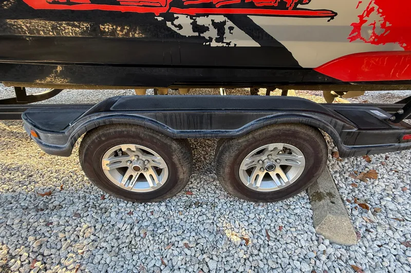 Slide: The Image of Trailer wheels of a 2008 MasterCraft XStar 23 boat on gravel surface. - 8