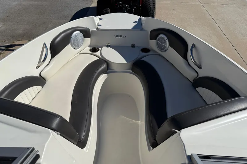 Slide: The Image of 2019 Stingray 198 LX boat interior with black and white seating and speakers. - 11