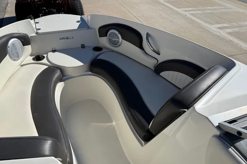 Slide: The Image of 2019 Stingray 198 LX boat interior with sleek seating and built-in speakers. - 13