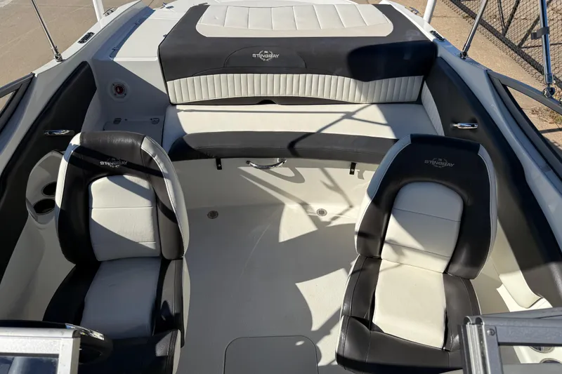 Slide: The Image of 2019 Stingray 198 LX boat interior with black and white seating, showcasing modern design. - 17