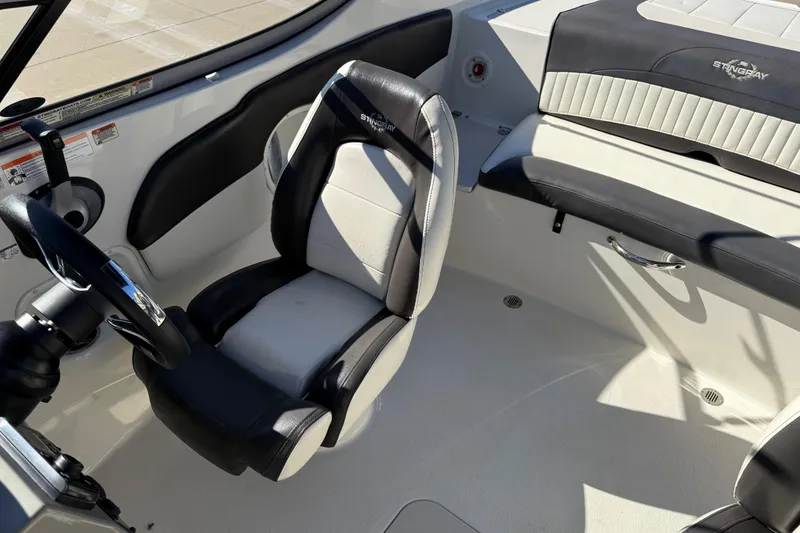 Slide: The Image of 2019 Stingray 198 LX boat interior with steering wheel and seating. - 18