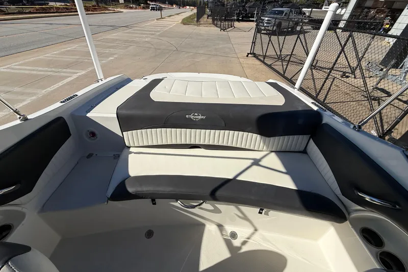Slide: The Image of 2019 Stingray 198 LX boat interior with cushioned seating and sleek design. - 20