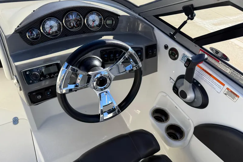 Slide: The Image of 2019 Stingray 198 LX boat dashboard with steering wheel and control panel. - 22