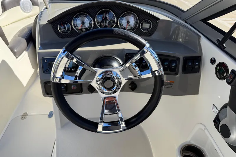 Slide: The Image of Steering wheel and dashboard of 2019 Stingray 198 LX boat, featuring modern controls. - 23
