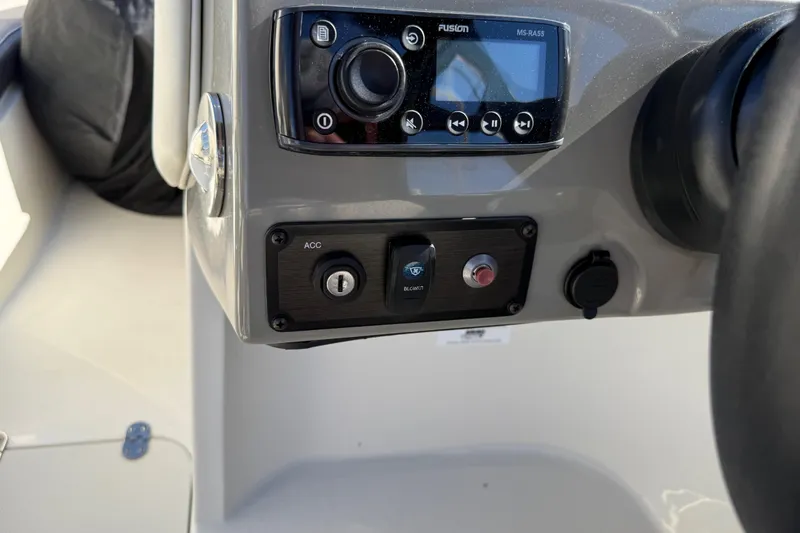 Slide: The Image of Dashboard controls of a 2019 Stingray 198 LX boat, featuring a Fusion audio system. - 26