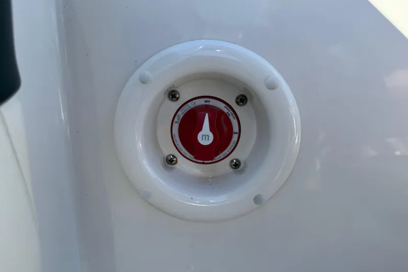 Slide: The Image of 2019 Stingray 198 LX boat battery switch, red and white, mounted on white surface. - 31
