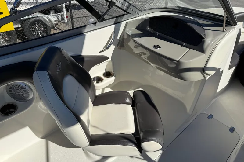 Slide: The Image of 2019 Stingray 198 LX boat interior with black and white seating and dashboard. - 32
