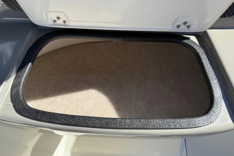 Slide: The Image of Open storage compartment in 2019 Stingray 198 LX boat, showcasing interior space. - 33