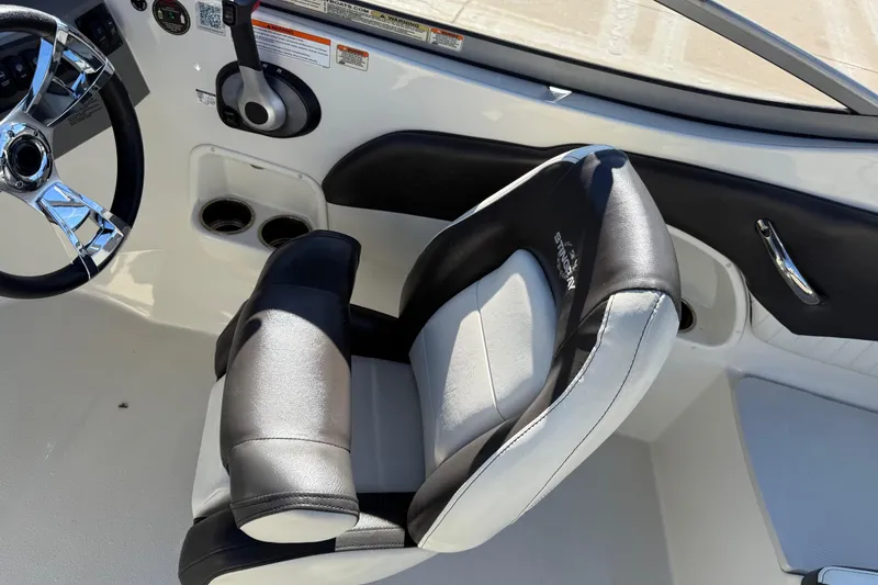 Slide: The Image of 2019 Stingray 198 LX boat interior with steering wheel and black-and-white seating. - 36