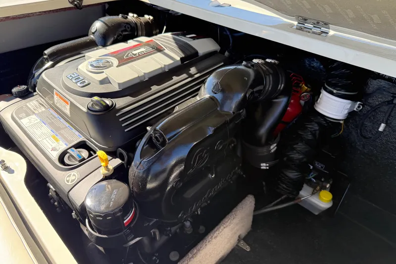 Slide: The Image of Engine compartment of a 2019 Stingray 198 LX boat, featuring a 200 horsepower motor. - 44