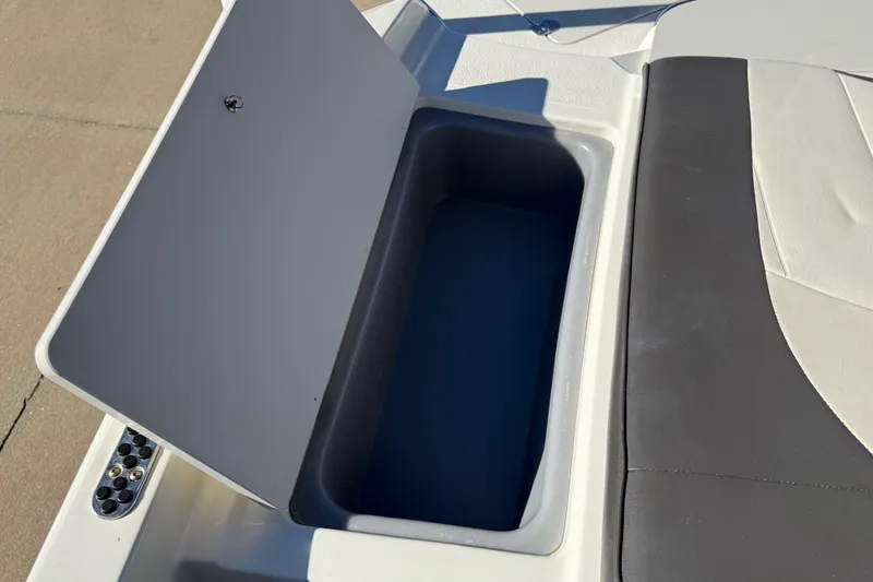 Slide: The Image of Open storage compartment on 2019 Stingray 198 LX boat, featuring sleek design and ample space. - 45