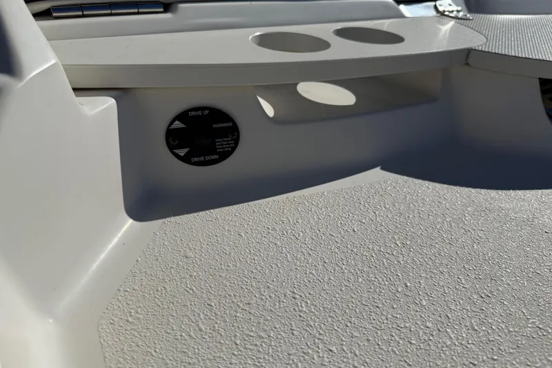 Slide: The Image of 2019 Stingray 198 LX boat interior with cup holders and control panel. - 48