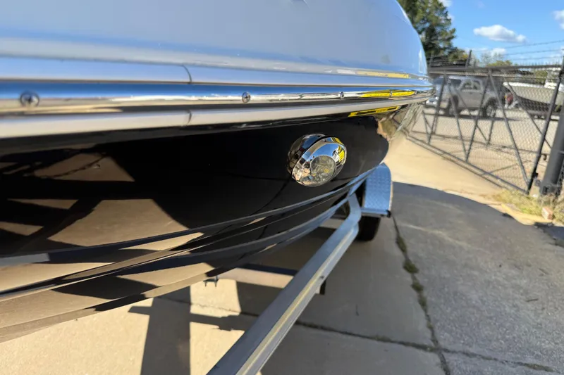Slide: The Image of 2019 Stingray 198 LX boat on trailer, close-up of hull and light. - 50