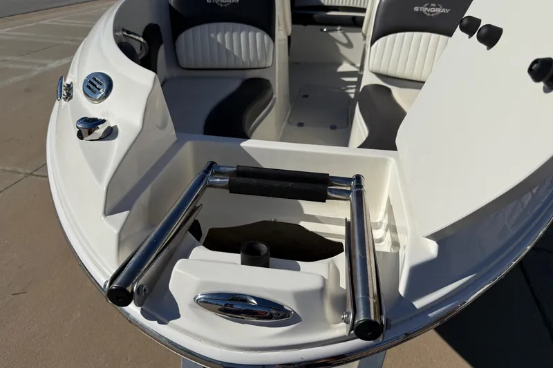 Slide: The Image of 2019 Stingray 198 LX boat bow with ladder and seating, showcasing sleek design. - 51