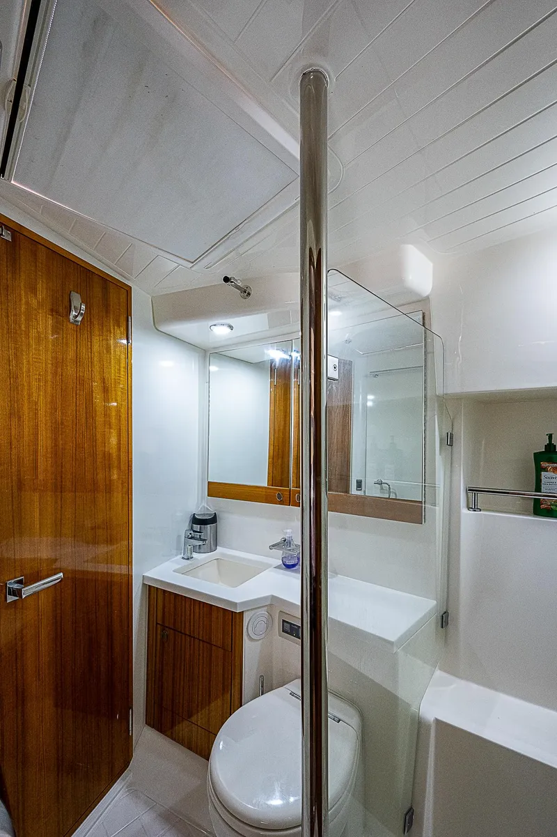 Slide: The Image of Luxurious interior of 2014 Maritimo 470 Offshore Convertible yacht with wooden stairs and plush seating. - 15