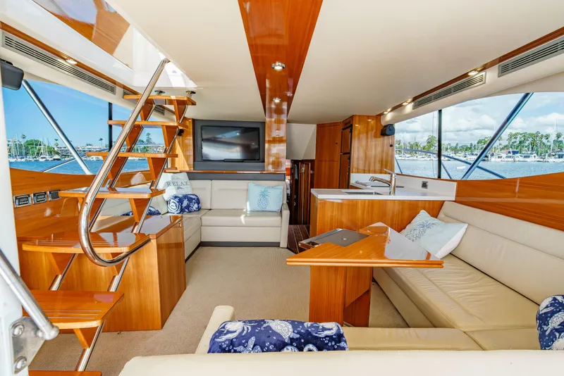 Slide: The Image of 2014 Maritimo 470 Offshore Convertible helm with navigation equipment and wooden accents. - 57