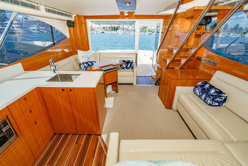 Slide: The Image of 2014 Maritimo 470 Offshore Convertible yacht interior with helm chairs and marina view. - 60